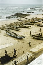 Fishing beach at Anomabu. A beach at Anomabu, covered with painted fishing boats and rows of