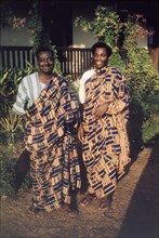 Men wearing kente cloth. Portrait of two Ghanaian men, Mr Amoako and Mr Ako, wearing traditional