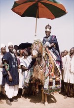 Fourth anniversary of Ghanaian independence. A Dagomba sub-chief or elder rides on a caparisoned