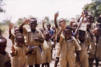 Ghanaian schoolboys wave goodbye. A group of uniformed schoolboys wave goodbye. Pong-Tamale, Ghana,