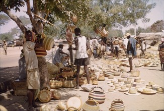 Baskets at Bolgatanga market. Shoppers browse a range of baskets and woven hats at Bolgatanga