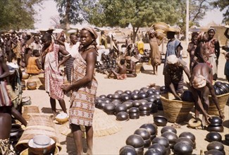 Pot section at Bolgatanga market. Traders and customers bustle about amidst the pot section at