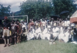Priests at the Ngmayem festival. Priests dressed in white sit in a group at an annual Ngmayem