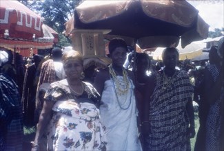Notable women at a Ngmayem festival. Three finely dressed women, possibly the wives of Manya Krobo