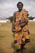 Traditional Ghanaian dress. Portrait of Mr Dako Mamphey wearing traditional Ghanaian kente cloth.