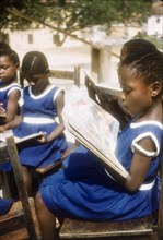 Schoolgirls read books from class library. Several young schoolgirls read books from the class