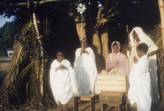 Ghanaian children perform a nativity play. Children in fancy dress perform a nativity play outdoors