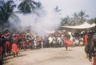 Asafo company firing guns. Members of Asafo Number Two Company swing flags and fire guns at a