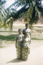Ghanaian girls in kente cloth. Portrait of three Ghanaian girls dressed in outfits made from