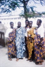 Men in traditional Ghanaian dress. A group of Ghanaian men pose for a portrait wearing traditional