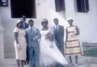 Ghanaian wedding party. A Ghanaian wedding party poses for a group portrait. Ghana, 23 April 1960.