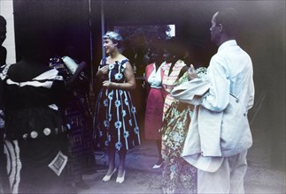 Wilma Gladstone's farewell party. A European woman chats to a group of Ghanaian friends at a