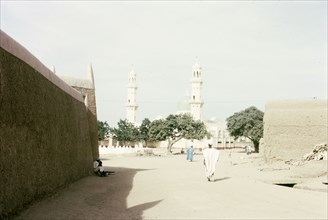 Kano Central Mosque. View down an urban road, looking towards the twin minarets of Kano Central