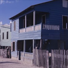 A blue house in Belize. Exterior view of a wooden, two-storey house in Belize. The building has