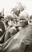 Portrait of two Kenyan women. Profile of two African women, one of whom carries a baby in a sling