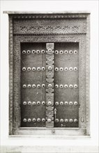 An ornate doorway in Kenya. An ornate wooden door in Lamu, decorated with studs and an intricately