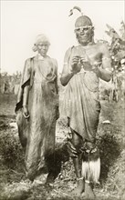 Two Kikuyu dancers. Full-length portrait of two Kikuyu dancers wearing traditional dress and