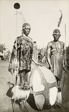 Two Maasai warriors. Full-length portrait of two Maasai warriors in traditional dress, holding