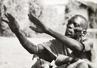 Debating at a Kikuyu council. A Kikuyu 'njama' (elder) talks animatedly during a debate at a