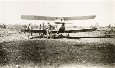 Light aircraft used to spot game. Several men surround a light aircraft used to spot game on safari