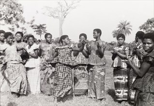A traditional Asante dance. Female students of a teacher training course clap and sing while one of