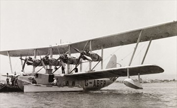 Imperial Airways flying boat. Men attend to an Imperial Airways flying boat resting on Lake