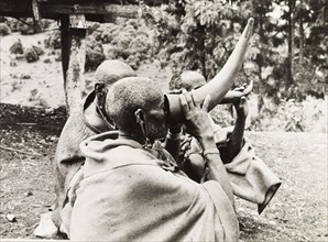 Kikuyu elders drinking beer. Kikuyu elders drink beer from hollow bullock horns, a privilege