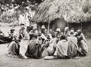 A meeting of Kikuyu elders. A group of Kikuyu men gather in a circle to drink beer from a hollow