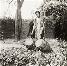 Asante man with atumpan drums. An Asante (Ashanti) man poses with a pair of ceremonial atumpan