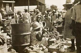 Street traders at a Jamaican market. Female street traders sell fruit, vegetables and smoked fish