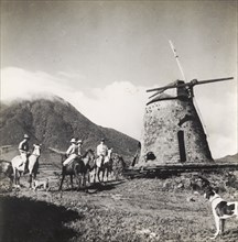 A derelict sugar mill in Nevis. European men on horseback visit a disused windmill on a sugar