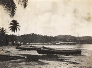 Port Maria beach. Fishing canoes sit on a sandy shore at Port Maria. Port Maria, Jamaica, circa