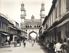 Street leading to the Charminar. Shops with awnings flank a street leading towards the Charminar