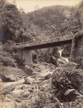 Road bridge across the Hope River. The Hope River runs belows a road bridge in the mountains. St