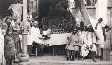 A vegetable stall in Hyderabad. Men, women and children pose for the camera beside a street stall