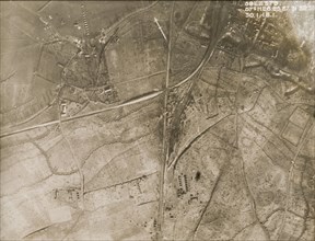 A military camp at a bomb-damaged village. One of a series of British aerial reconnaissance