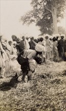 Wrestling match in Sukkur . A crowd of spectators gathers to watch a wrestling match in a grassy