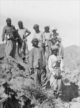 Indian men in the mountains. A group of Indian men pose for the camera on a rocky outcrop in the