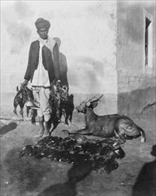 A 'shikari' displays the day's catch. An Indian 'shikari' (professional hunter) displays the