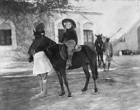 Riding a pony led by a 'sowar'. Margaret Lawrence (b.1904), the daughter of Phyllis and Sir Henry
