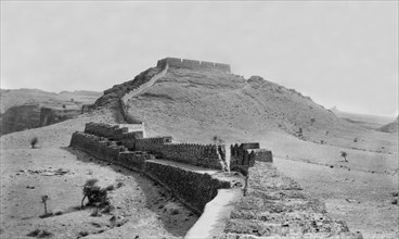 Fort wall in Kohistan . The defensive outer wall of a hill fort runs along the peak of a hill in