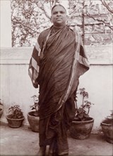 Portrait of an Indian man. An Indian man in traditional, possibly religious robes, poses outdoors