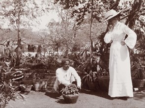 Phyllis Lawrence watches a gardener at work. Phyllis Louise Lawrence, the first wife of Sir Henry