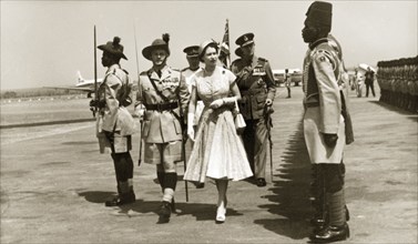 Queen Elizabeth II arrives at Kaduna airport. Queen Elizabeth II inspects the newly renamed Queen's