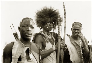 Nigerian hunters with bows and arrows. Portrait of three Nigerian hunters holding bows and arrows.