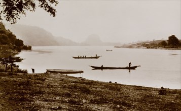 Juju Rock from the River Niger. Canoes float in the calm waters of the River Niger close to Juju