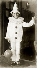 A British boy in fancy dress. Portrait of a British boy wearing a Pierrot clown costume at a fancy