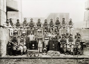 Construction engineers in diving suits. A team of British and Chinese civil engineers pose for a