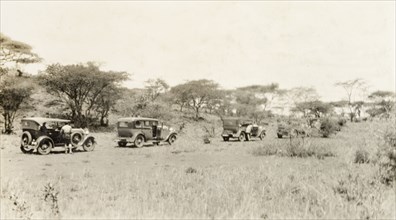 Leaving on a cross-Africa safari. A convoy of cars prepares to set out on a cross-Africa safari. An