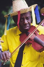 Violinist at the Caribbean Music Village. A musician plays a violin at the Caribbean Music Village,